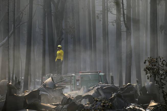 A firefighter stands on top of a fire truck at a campground destroyed by the Rim Fire near Yosemite National Park, Calif., on Monday, Aug. 26, 2013. Crews working to contain one of California's largest-ever wildfires gained some ground Monday against the flames threatening San Francisco's water supply, several towns near Yosemite National Park and historic giant sequoias.