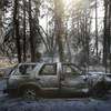Photo: A burned SUV sits in front of a campground destroy Photo: A burned SUV sits in front of a campground destroy