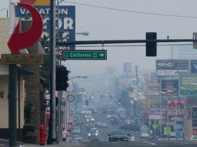 A smoky haze blankets Virginia Street headed south from the main downtown casino strip near California Street as health district officials raised an air quality alert to the "red" unhealthy level, Friday afternoon, Aug. 23, 2013 in Reno, Nev. The smoke from a massive wildfire burning 150 miles to the south at Yosemite National Park prompted school officials to keep children inside Friday in Carson City, and Washoe and Douglas counties.