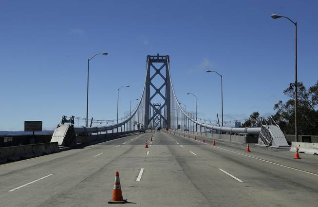 Cones line empty lanes as construction crews work on the western section of the San Francisco-Oakland Bay Bridge, which is closed to traffic, in San Francisco, Calif., Thursday, Aug. 29, 2013. Commuters faced their first morning on Thursday without the bridge, but there weren't major traffic snarls as day broke across the Bay Area.