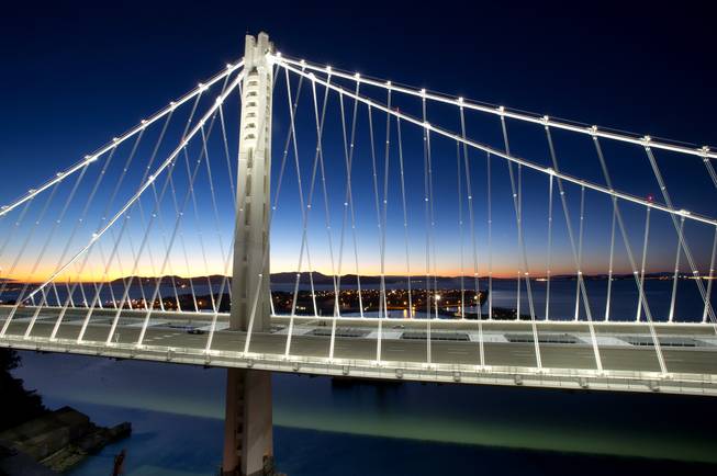 In a handout photo provided by the Bay Area Toll Authority, LED lights illuminate the San Francisco-Oakland Bay Bridge's self-anchored suspension on Thursday, Aug. 29, 2013, in San Francisco. With traffic between Oakland and San Francisco halted over Labor Day weekend for construction, bridge officials say the new span will open by Tuesday morning.