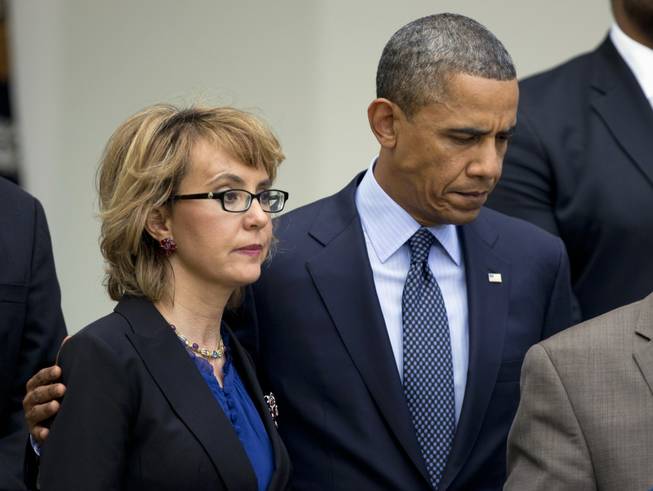 In this April 17, 2013, file photo, President Barack Obama puts his arm around former Arizona Rep. Gabrielle Giffords before speaking in the Rose Garden at the White House in Washington about measures to reduce gun violence. Striving to take action where Congress would not, the Obama administration announced new steps Thursday on gun control, curbing the import of military surplus weapons and proposing to close a little-known loophole that lets felons and others circumvent background checks by registering guns to corporations.