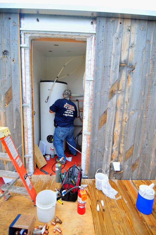A contractor is working to install a water heater in UNLV's Desert Sol project, a solar house that will operate entirely on renewable energy, on Friday, August 30, 2013. Desert Sol will travel to Irvine, Calif., in September to compete against 19 other teams from around the world in the U.S. Department of Energy's Solar Decathlon competition.