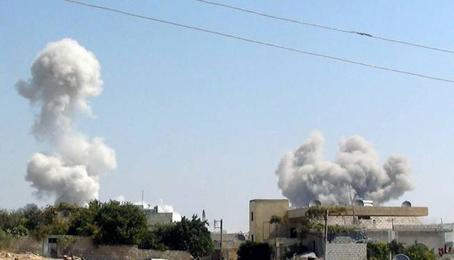 In this citizen journalism image provided by Edlib News Network, ENN, which has been authenticated based on its contents and other AP reporting, smoke rises after explosives were dropped by a Syrian government warplane, in Idlib province, northern Syria, Friday, Aug. 30, 2013.