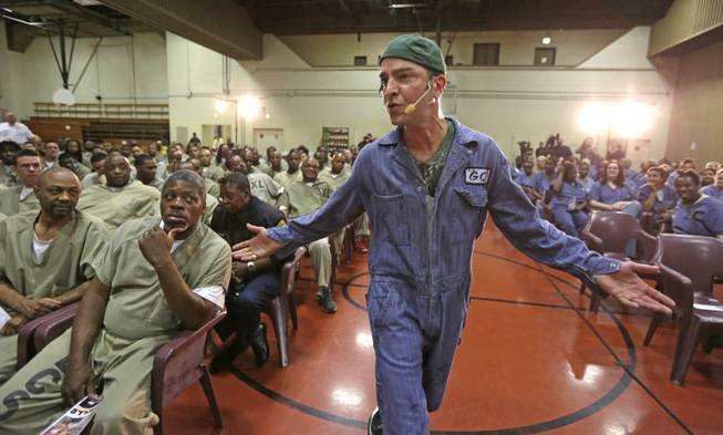 In this Aug. 27, 2013, photo, rapper GQ, aka Gregory Qaiyum, performs during a hip hop adaptation of William Shakespeare's Othello, titled "Othello: The Remix" at the Cook County Jail in Chicago. "Shakespeare was a master storyteller who used musical language and poetry," GQ says, and the same is true of the best rappers. "So at the very basic level theyre doing the exact same thing. ... You're using poetic devices like alliteration and repetition and onomatopoeia. ... They're very similar art forms despite how different they tend to be judged." (AP Photo/M. Spencer Green)