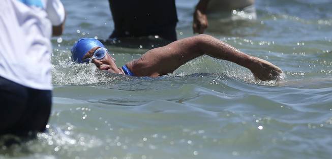 Long distance swimmer Diana Nyad swims towards shore in Key West, Fla., Monday, Sept. 2, 2013, after swimming from Cuba. Nyad became the first person to swim from Cuba to Florida without the help of a shark cage. She arrived at the beach just before 2 p.m. EDT, about 53 hours after she began her swim in Havana on Saturday.