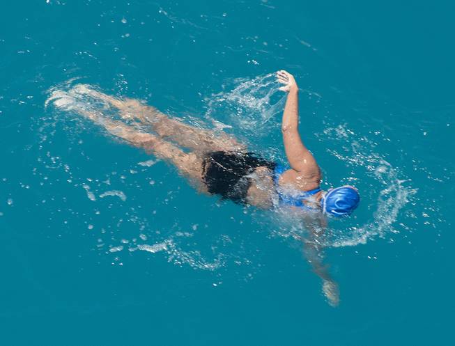 In this photo provided by the Florida Keys News Bureau, Diana Nyad, positioned about two miles off Key West, Fla., Monday, Sept. 2, 2013, swims towards the completion of her approximately 110-mile trek from Cuba to the Florida Keys. Nyad, 64, is the first swimmer to cross the Florida Straits without the security of a shark cage.