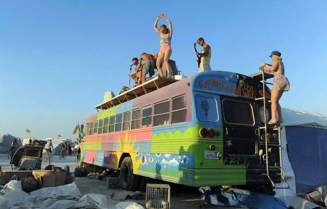 In this Thursday, Aug. 29, 2013 photo, a band plays on top of a bus at Burning Man in Gerlach, Nev. Once a year, tens of thousands of participants gather for Burning Man in Nevada's Black Rock Desert to create Black Rock City, dedicated to community, art, self-expression and self-reliance.