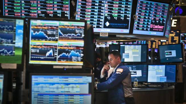 Jason Hardzewicz, a floor official and trader for Barclays, works at his post on the floor of the New York Stock Exchange, Friday, Aug. 30, 2013, in New York. Disappointing news on consumer spending helped pull stocks lower Friday in a quiet end to the market's worst month in more than a year.
