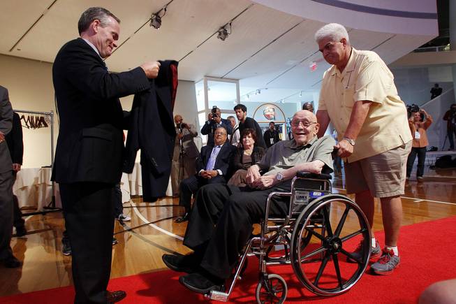 Former UNLV coach Jerry Tarkanian is presented with his jacket by Hall of Fame President and CEO John Doleva during a news conference before his induction into the Naismith Memorial Basketball Hall of Fame Saturday, Sept. 7, 2013 in Springfield, Mass. Assisting Tarkanian is long time friend Gil Castillo.