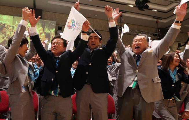 Japan's Prime Minister Shinzo Abe, center; governor of Tokyo and chairman of Tokyo 2020, Naoki Inose, second from left; and other members of the Japanese delegation celebrate as International Olympic Committee President Jacques Rogge announces that Tokyo will host the 2020 Olympic Games during the 125th IOC session in Buenos Aires, Argentina, on Saturday, Sept. 7, 2013.