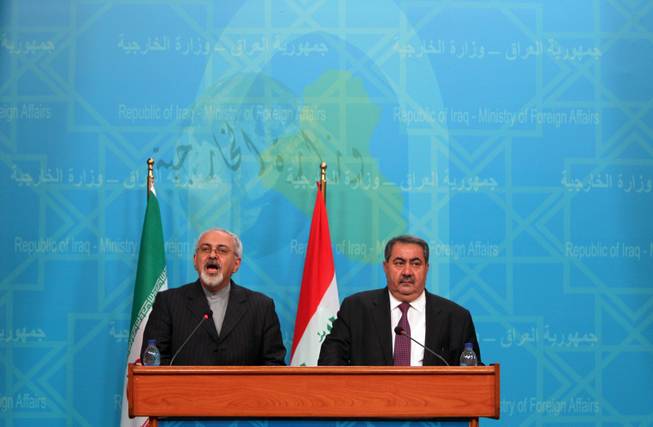 Iranian Foreign Minister Mohammad Javed Zarif (L) speaks during a joint press conference with his Iraqi counterpart Hoshyar Zebari in Baghdad on September 8, 2013. Javad Zarif slammed potential US-led airstrikes against Syria as "illegal" on a visit to Baghdad Sunday, while his Iraqi counterpart warned they would hinder efforts towards a political solution.