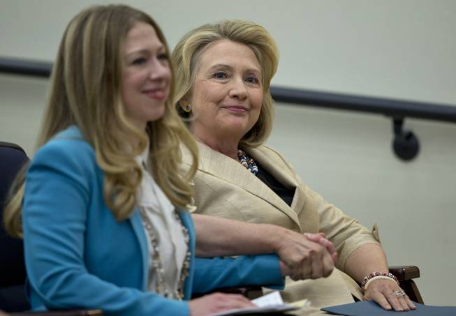 Former Secretary of State Hillary Rodham Clinton sits with he daughter Chelsea Clinton before she speaks about Syria, Monday, Sept. 9, 2013, in the South Court Auditorium on the White House Complex in Washington, during a the White House Forum to Combat Wildlife Trafficking. Clinton said any move by Syria to surrender its chemical weapons to international control would be an "important step."