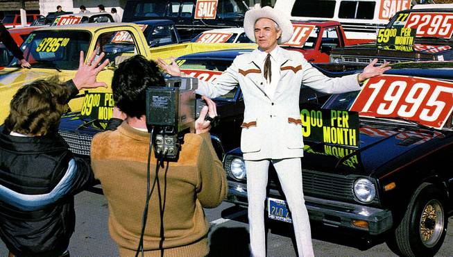 In this 1985 photo, auto dealer Cal Worthington tapes a commercial in Los Angeles. Worthington, who built a fortune from a series of West Coast car dealerships and became a TV fixture thanks to commercials urging customers to "go see Cal," died Sunday, Sept. 8, 2013. He was 92.