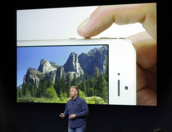 Phil Schiller, Apple's senior vice president of worldwide product marketing, speaks on stage about the camera quality during the introduction of the new iPhone 5s in Cupertino, Calif., Tuesday, Sept. 10, 2013. Apples latest iPhones will come in a bevy of colors and two distinct designs, one made of plastic and the other that aims to be the gold standard of smartphones and reads your fingerprint.