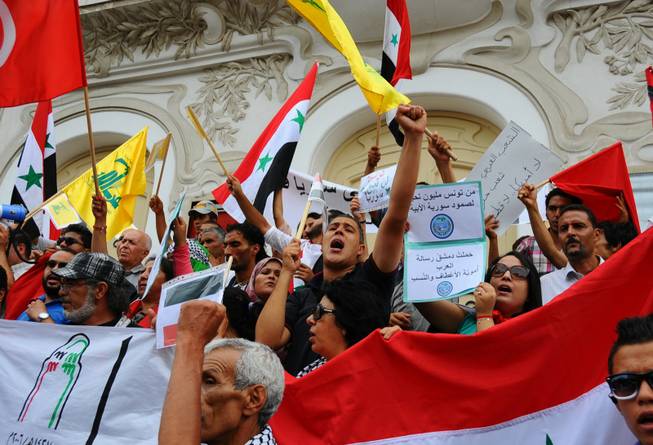 Demonstrators shout during a rally against possible U.S strike on Syria, Tuesday, Sept. 10, 2013, in Tunis. U.S. President Barack Obama is going to Congress on Tuesday with fresh hopes of a diplomatic breakthrough that would allow Syria's government to avoid U.S. missile strikes if it surrenders its chemical weapons arsenal.