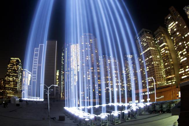 In a photo made with a fisheye lens, the Tribute in Light rises above buildings in lower Manhattan, during a test, Tuesday, Sept. 10, 2013 in New York. The light display commemorates the twin towers of the World Trade Center that were destroyed in terrorist attacks 12 years ago on Sept. 11, 2001. (AP Photo/Mark Lennihan)