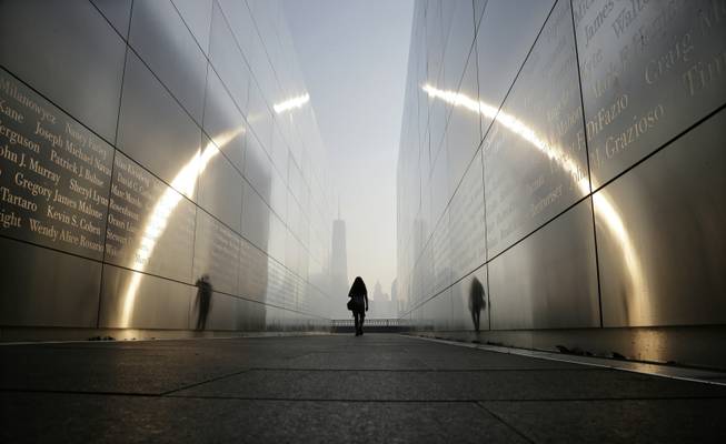 A visitor walks through the "Empty Sky" memorial to New Jersey's victims of the Sept. 11, 2001 terrorist attacks on Wednesday, Sept. 11, 2013, in Jersey City, N.J. One World Trade Center is visible across the Hudson River. Ceremonies will be held Wednesday to mark the 12th anniversary of the attacks.
