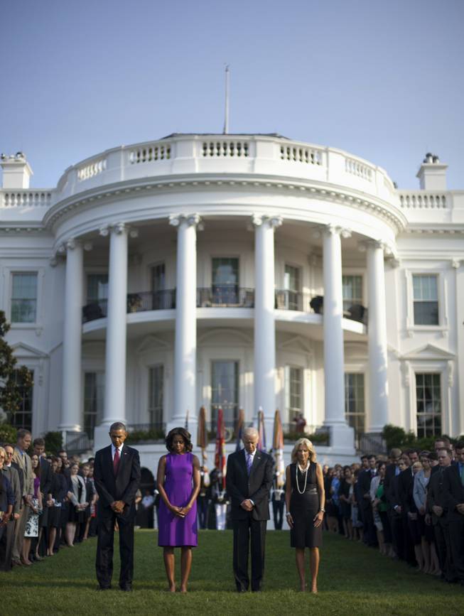 President Barack Obama, first lady Michelle Obama, Vice President Joe Biden and Jill Biden join members of the White House staff during a moment of silence to mark the 12th anniversary of the 9/11 attacks, Wednesday, Sept. 11, 2013, on the South Lawn of the White House in Washington.