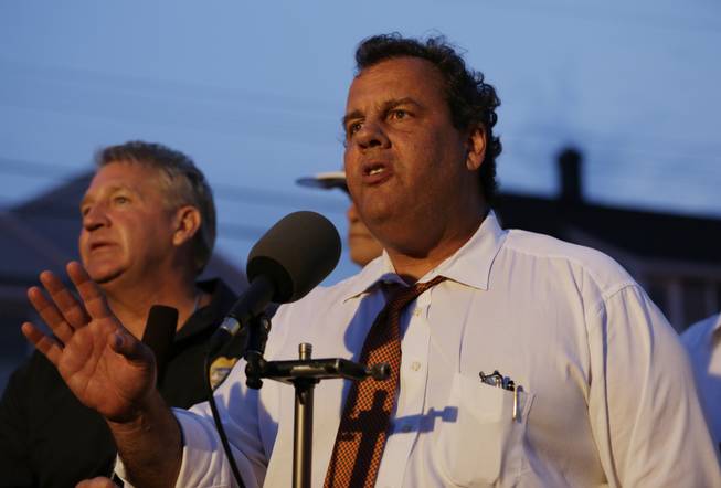 New Jersey Gov. Chris Christie addresses the media near the area hit by a massive fire on Thursday, Sept. 12, 2013, in Seaside Park, N.J. The fire began in a frozen custard stand on the Seaside Park section of the boardwalk and quickly spread north into neighboring Seaside Heights.