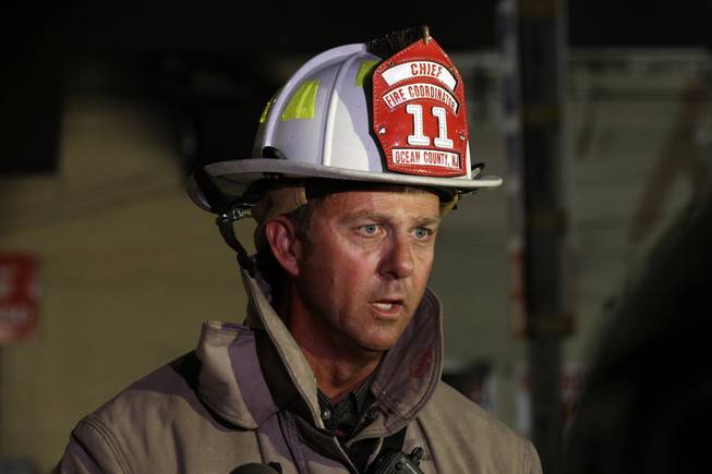 Ocean County fire coordinator Brian Gabriel addresses the media near the site of a massive fire at Seaside Park boardwalk, Thursday, Sept. 12, 2013, in Seaside Park, N.J. The fire, which apparently started in the area of an ice cream shop and spread several blocks, hit the recently repaired boardwalk, which was damaged last year by Superstorm Sandy. There were no other early reports of any injuries.