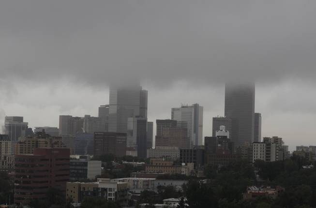 A wall of a clouds enshrouds the high-rise buildings of downtown Denver early Friday, Sept. 13, 2013., as heavy rains continue to pummel cities along Colorado's Front Range. Heavy, stationary rainstorms have wreaked havoc on cities and communities along the Front Range and into the foothills since Wednesday with more rain forecasted for the weekend ahead.