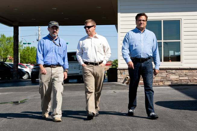 Las Vegas Sun Publisher Donn Jersey, center, walks with reporter Matt Hufman and cartoonist Mike Smith, right, to accept delivery of a 1997 Land Rover Defender Hufman and Smith will drive exploring Nevada over the next year working on the Finding Nevada Project at the Land Rover Las Vegas dealership Friday, September 13, 2013.