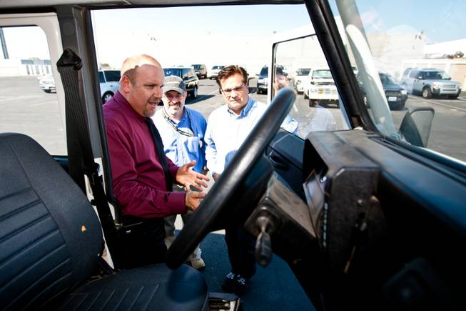 Rick Nelson (right), Land Rover event and social media director, explains the interior features of the 1997 Land Rover Defender to Matt Hufman and Mike Smith, right, as they prepare to explore Nevada over the next year working on the Finding Nevada Project at the Land Rover Las Vegas dealership Friday, September 13, 2013.
