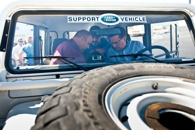 Rick Nelson (left), Land Rover event and social media director, explains the interior features of the 1997 Land Rover Defender to Mike Smith, from right, and Matt Hufman as they prepare to explore Nevada over the next year working on the Finding Nevada Project at the Land Rover Las Vegas dealership Friday, September 13, 2013.