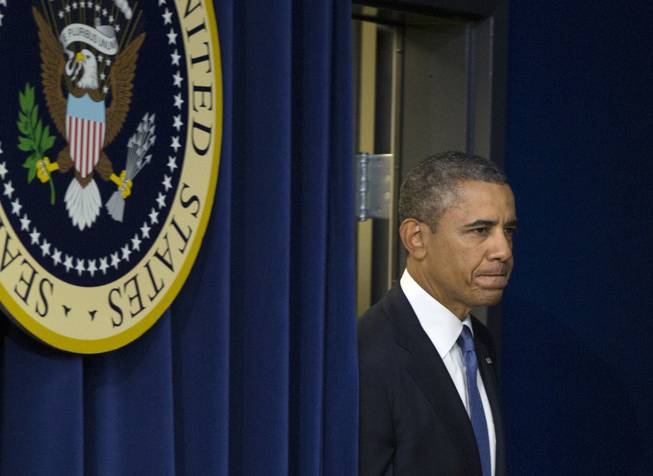 President Barack Obama arrives to speak in the South Court Auditorium on the White House complex, Monday, Sept. 16, 2013, in Washington. Before speaking about the economy Obama spoke on the shooting at the Washington Navy Yard, mourning what he called "yet another mass shooting" in the United States that he says took the life of American patriots.