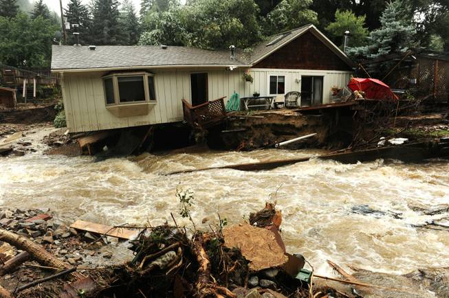 What looks like a river in fact used to be the front and back yards of the residents of these homes in Jamestown, Colo., on Sunday Sept. 15, 2013. People in the town say the the Little Jim Creek which used to flow quietly through town has changed course and is tearing apart properties and houses as it continues to rage.