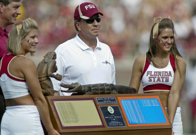 Florida State director of athletics Randy Spetman (far left) and Florida State head coach Jimbo Fisher stand behind cheerleaders holding The Makala Trophy between the first and second quarters of their NCAA spring college football game Saturday, April 14, 2012, in Tallahassee, Fla. The traveling trophy goes to the winner of the annual football game between rivals Florida State and Florida.