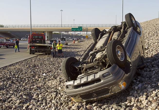 A Mercury Mountaineer SUV is shown on its roof after a rollover accident on I-215 westbound by Windmill Lane Wednesday, Sept. 18, 2013. The use of seat belts kept the occupants from suffering serious injuries, said NHP Trooper Robert Borchardt. A five year old boy was taken to the hospital to be checked out, he said.