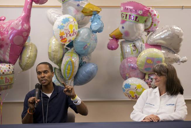 Deon Derrico, left, speaks about the birth of his quintuplets during a news conference with Dr. Martha Knutsen, Friday, Sept. 20, 2013, at Summerlin Hospital Medical Center in Las Vegas. Born in Phoenix two weeks ago, Derrico and other members of his family took three different medical flights to shuttle all five infants back to their home in Las Vegas on Friday.