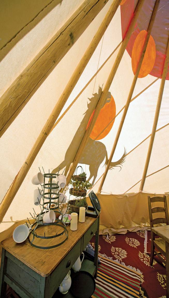 This July 26, 2013, photo shows a fully furnished tipi at the Mustang Monument Wild Horse Eco Resort in south of Wells, Nev. The resort has a herd of about 700 free-roaming horses, and aims to be an engine for the nonprofit organization Saving America's Mustangs.