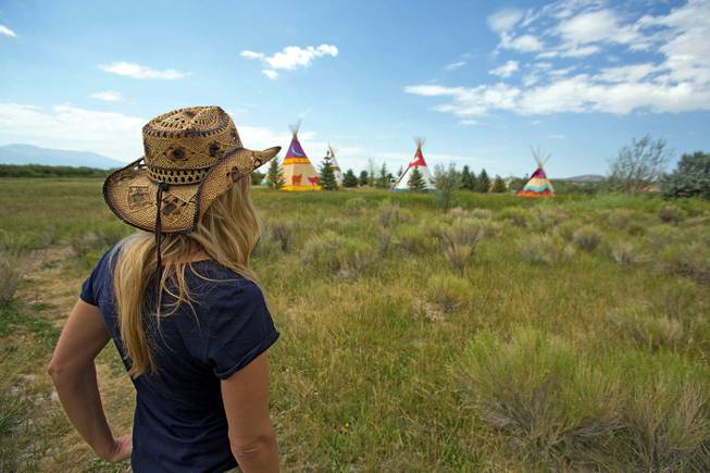 This July 26, 2013, photo shows Mustang Monument Sales and Marketing Manager Kristina Carlson guiding a tour at the Mustang Monument Wild Horse Eco Resort in Wells, Nev. The resort has a herd of about 700 free-roaming horses, and aims to be an engine for the nonprofit organization Saving America's Mustangs.