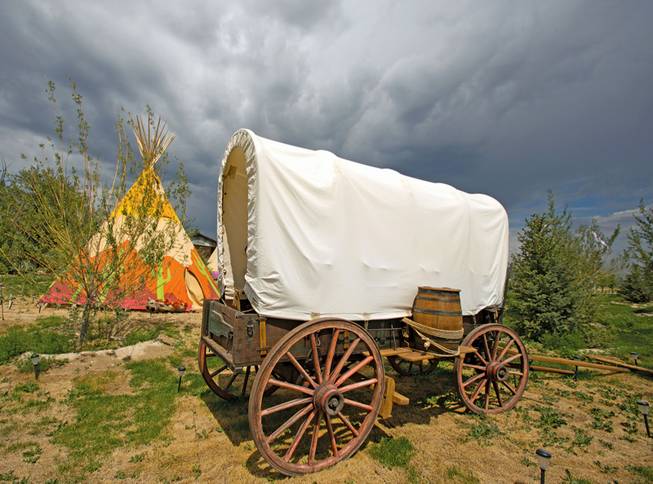 his July 26, 2013, photo shows a covered wagon that is part of the landscape with a variety of teepees that are available as accommodations at the Mustang Monument Wild Horse Eco Resort in Wells, Nev. The resort has a herd of about 700 free-roaming horses, and aims to be an engine for the nonprofit organization Saving America's Mustangs.