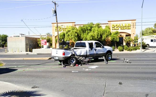 The scene of a two-vehicle crash at Bonanza Road and Lamb Boulevard in which, Metro Police said, a pickup truck careened into a bus stop. Three children at the bus stop were injured, police said. The white ford truck that hit a bus stop on bonanza, pieces of bus stop can be seen under car, Friday, Sept. 20, 2013.