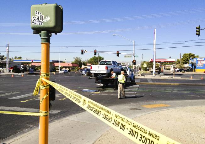 The scene of a two-vehicle crash at Bonanza Road and Lamb Boulevard in which, Metro Police said, a pickup truck careened into a bus stop. Three children at the bus stop were injured, police said. This is the dodge truck that was headed west on lamb being towed off, Friday, Sept. 20, 2013. This truck hit the other truck sending it into a bus stop.