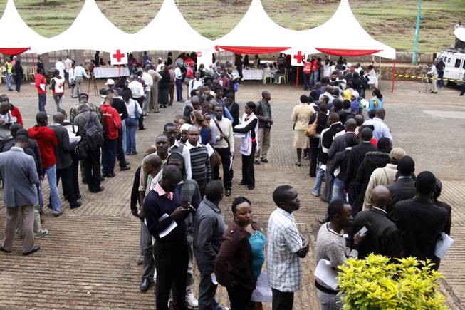Kenyans line up to donate blood for victims in Sunday's terrorist attack on a shopping mall, at Uhuru Park in Nairobi, Kenya Monday, Sept. 23, 2013. Hostages being held by al-Qaida-linked terrorists in the mall have not been released despite an earlier statement from the military that "most" had been rescued, a person connected to the situation told The Associated Press on Monday.