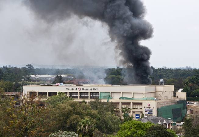 A plume of black smoke billows over the Westgate Mall, in Nairobi, Kenya Monday, Sept. 23, 2013. Multiple large blasts have rocked the mall where a hostage siege is in its third day. Associated Press reporters on the scene heard multiple blasts and a barrage of gunfire. Security forces have been attempting to rescue an unknown number of hostages inside the mall held by al-Qaida-linked terrorists.