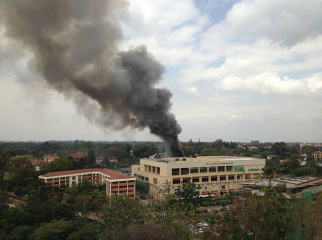 Heavy smoke rises from the Westgate Mall in Nairobi Kenya Monday Sept. 23 2013. Multiple large blasts have rocked the mall where a hostage siege is in its third day. Associated Press reporters on the scene heard multiple blasts and a barrage of gunfire. Security forces have been attempting to rescue an unknown number of hostages inside the mall held by al-Qaida-linked terrorists. (AP Photo/ Jerome Delay)