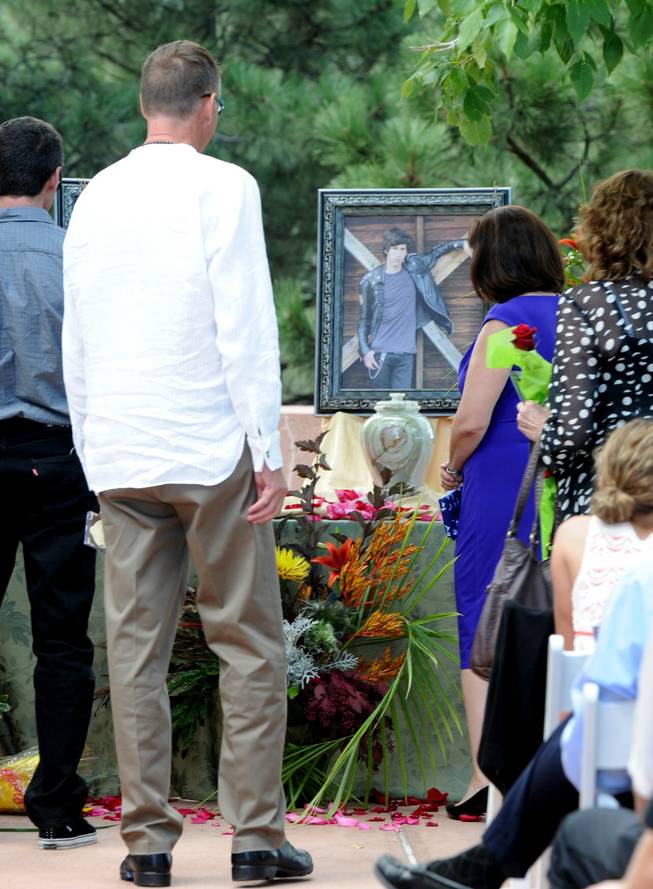 Ron Quinlan and Glenda Aretxuloeta, look at the portrait of their son, Wesley, after the memorial service. A memorial service for Wiyanna Nelson and Wesley Quinlan was held at NCAR in Boulder, Colo., on Saturday, Sept. 21, 2013. The teenagers were killed in the flood waters in Boulder last week. Wiyanna Nelson