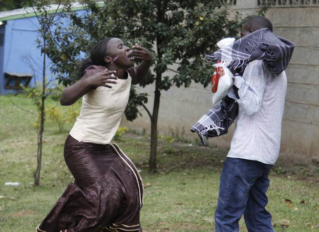 Ann Gakii, left, reacts at the Nairobi City Mortuary after identifying the body of her father, who was killed in the mall attack, in Nairobi, Kenya, Tuesday, Sept. 24, 2013. Islamic militants who staged a deadly attack on a Kenya mall said Tuesday hostages are still alive and fighters are still holding their ground, as Nairobis city morgue prepared for the arrival of a large number of bodies of people killed, an official said.