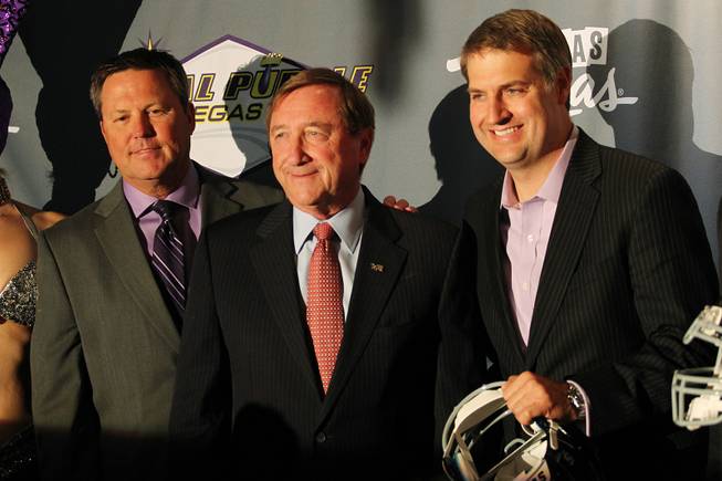 Royal Purple Las Vegas Bowl Executive Director Executive Director Dan Hanneke, Las Vegas Visitors and Convention Authority President Rossi Ralenkotter and Royal Purple President Bryan Yourdon pose for a photo during the kickoff luncheon for the annual bowl game Wednesday, Sept. 25, 2013. Royal Purple, a manufacturer of motor oil and other lubricants, was announced as the new title sponsor of the game for the next three years.