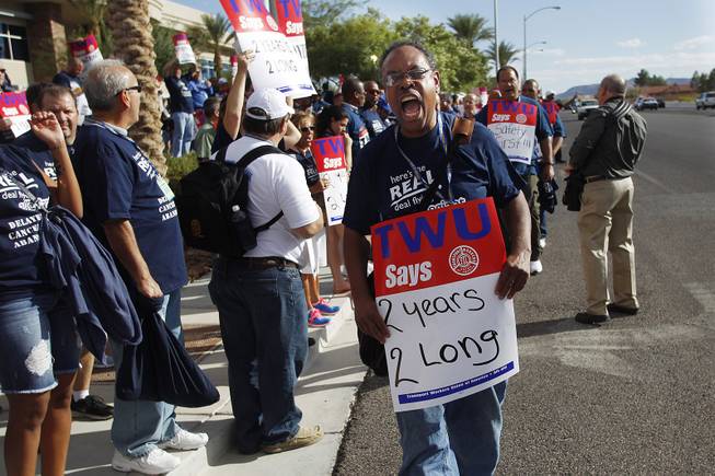 Transit Workers Union member Donald Dennison chants while joining over 300 other union members, in town for their convention, in a picket outside of Allegiant Air headquarters Thursday, Sept. 26, 2013. The union members were trying to raise awareness of Allegiant's customer service record as well as their inability to reach a labor agreement with more than 600 of their flight attendants.