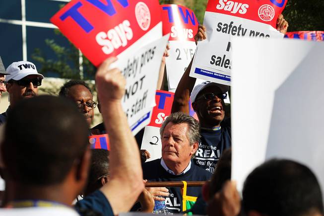 Transit Workers Union President Harry Lombardo, center, speaks to over 300 union members, in town for their convention, as they picket outside of Allegiant Air headquarters Thursday, Sept. 26, 2013. The union members were trying to raise awareness of Allegiant's customer service record as well as their inability to reach a labor agreement with more than 600 of their flight attendants.