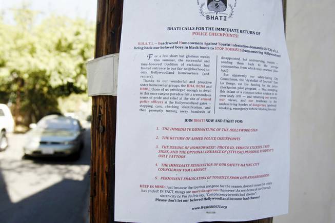 A flier attached to a pole on Westshire Drive is seen Sept. 26, 2013, in the Beachwood Canyon area of Los Angeles. Residents in the Beachwood Canyon area of Los Angeles are fighting with the Hollywoodland Homeowners Association over tourists looking at the Hollywood sign.