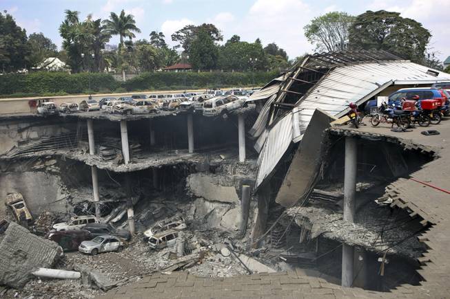 This photo provided by the Kenya Presidency shows the collapsed upper parking deck atop the Westgate Mall in Nairobi, Kenya, Thursday, Sept. 26, 2013. Kenya’s military caused the massive collapse of three floors of Nairobi’s Westgate Mall during the terrorist siege in which at least 67 people died, a top-ranking government official told The Associated Press.