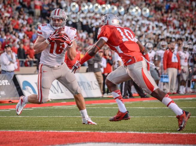 UNLV's tight end Taylor Barhill, left, turns around after making a catch and scores a touchdown Saturday evening Sept. 28, 2013, at University Stadium in Albuquerque, N.M. Defending on the play for UNM on the right is Rashad Rainey. At the half the score remained tied 35-35. (AP Photo/Albuquerque Journal, Roberto E. Rosales)